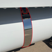 Close-up showing Iowa Customs stainless 4-inch fuel tank strap skin alignment on a Peterbilt — highlighted outline showing precision fit.