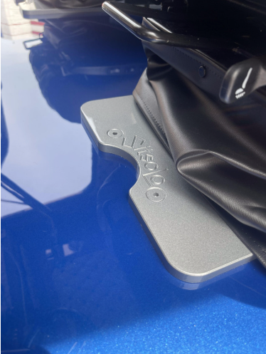 Iowa Customs 8-inch billet aluminum seat base adapter installed on a Peterbilt seat base – close-up view showing precision fit and polished finish.